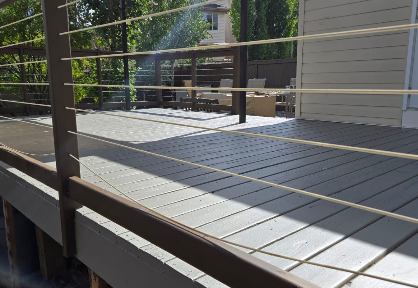The same deck after refinishing in a solid grey-taupe coat
