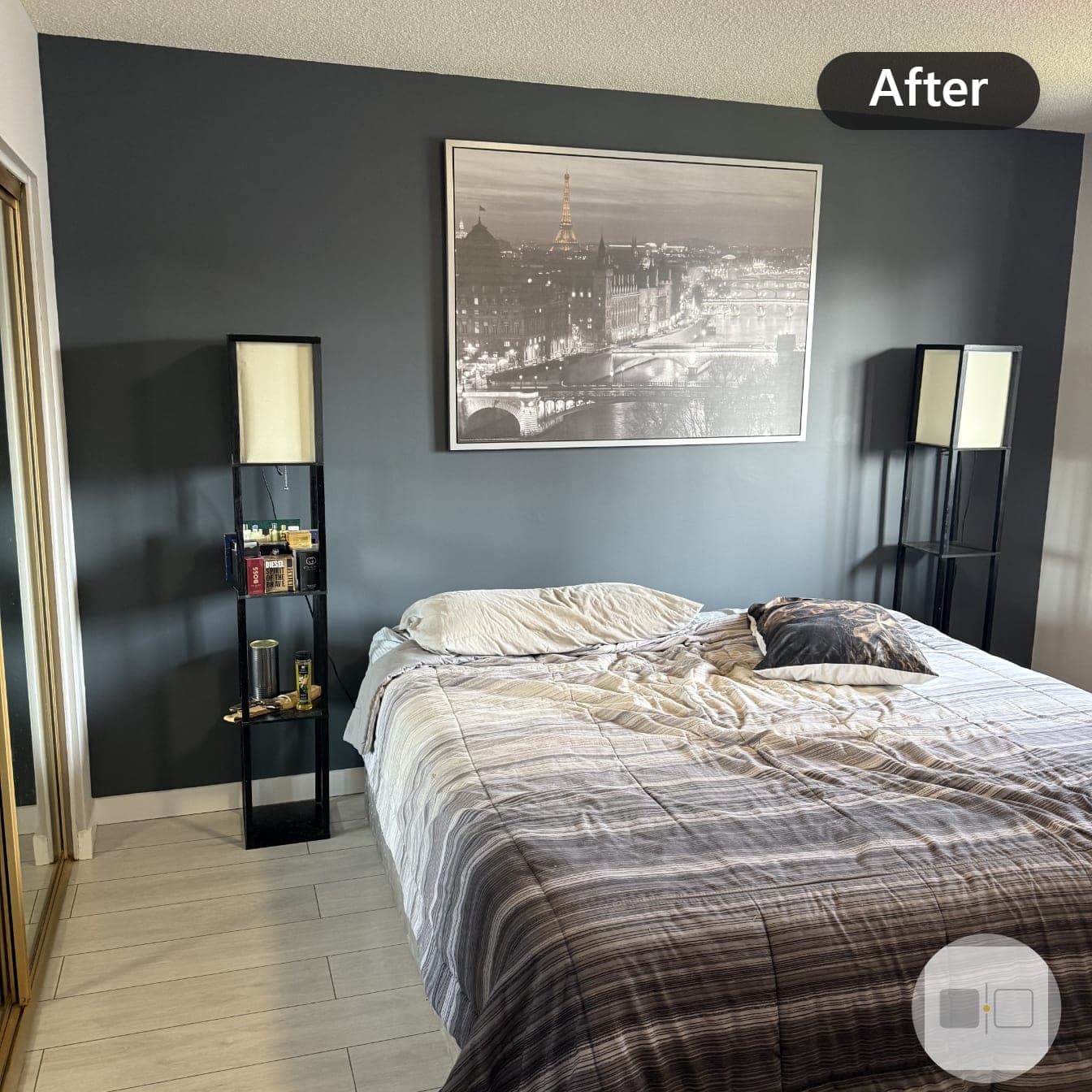 The same bedroom after painting, the wall behind the bed finished in deep slate blue